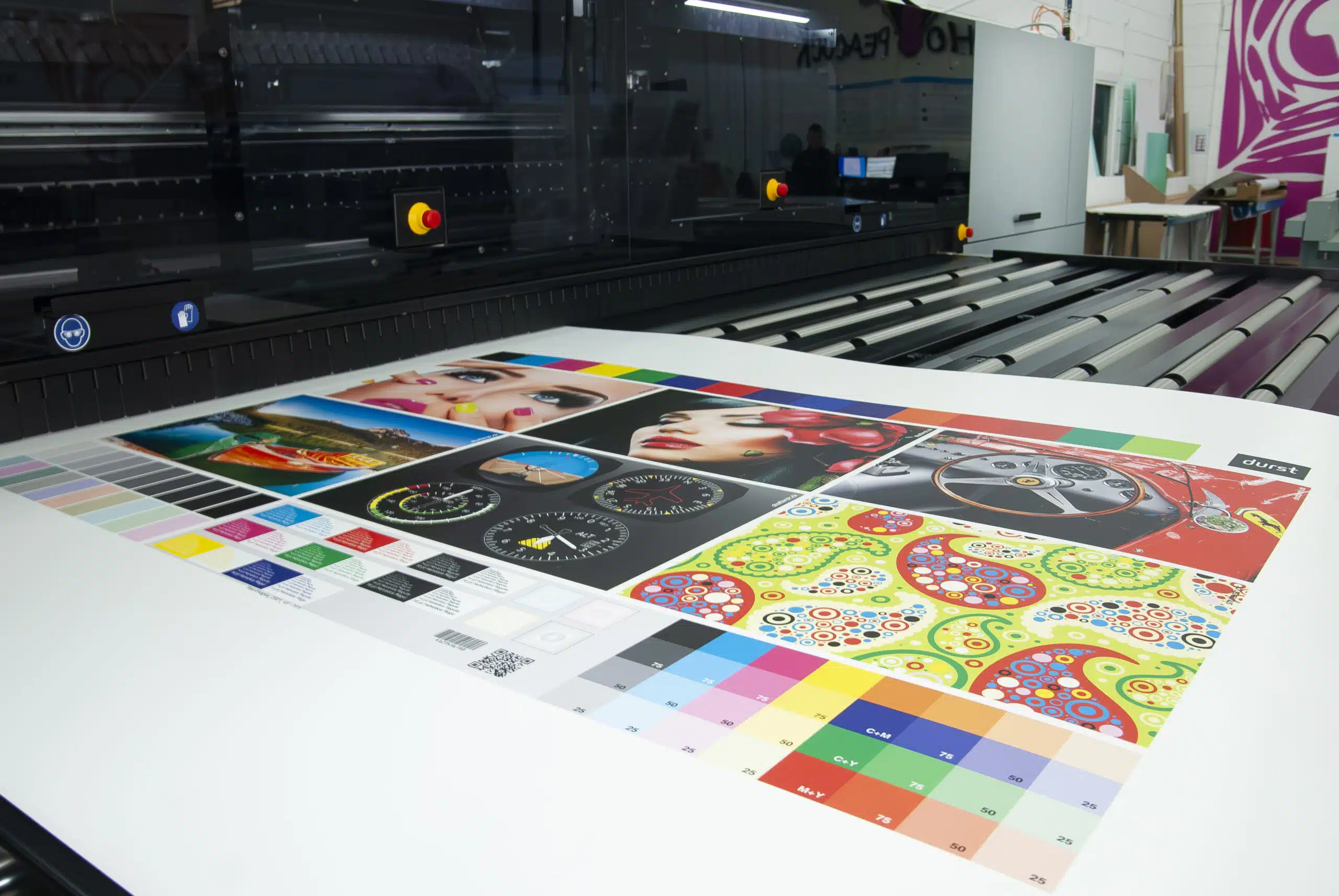 Large format prints laid out on the production floor