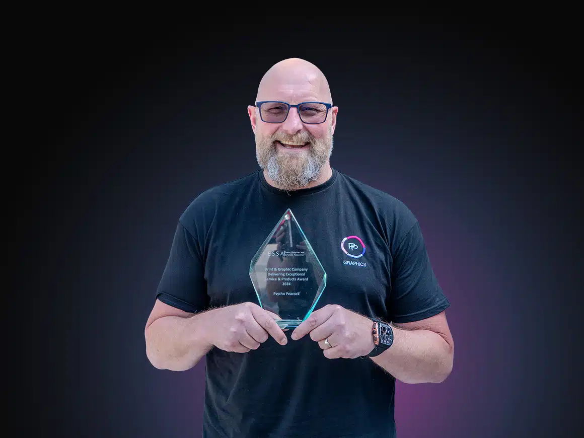 PP Graphics team member holding an ESSA award