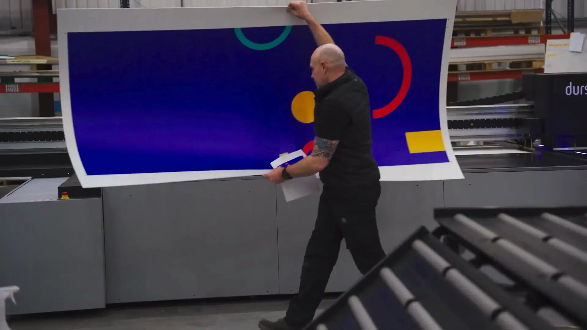Team member applying a large format graphic