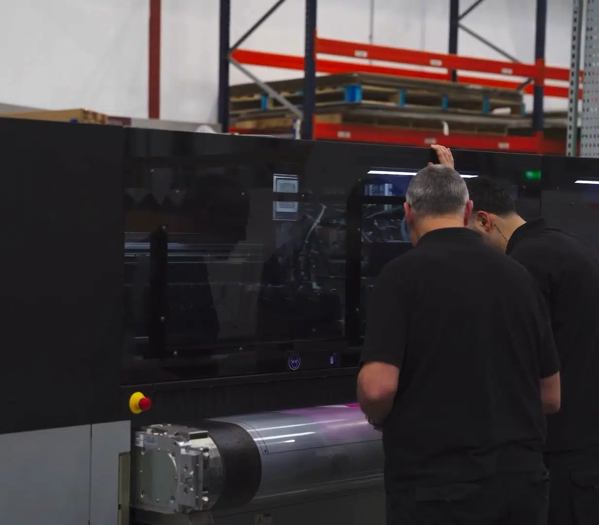 Team member operating a large format printer