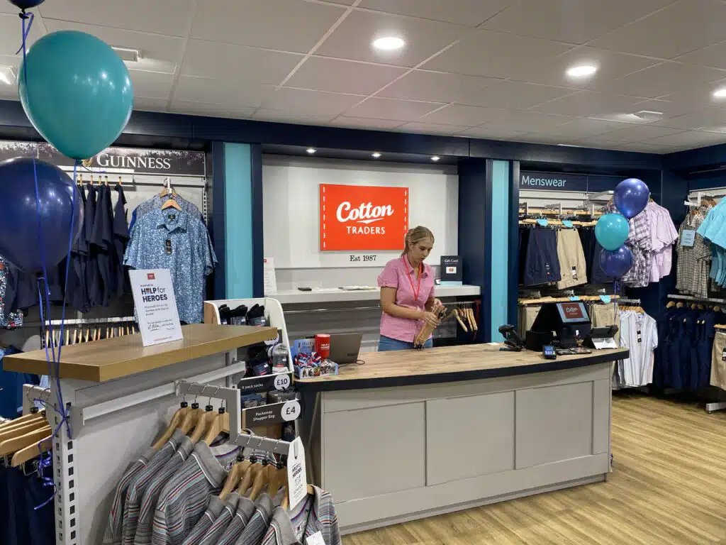 Cotton Traders store counter with balloons on opening day