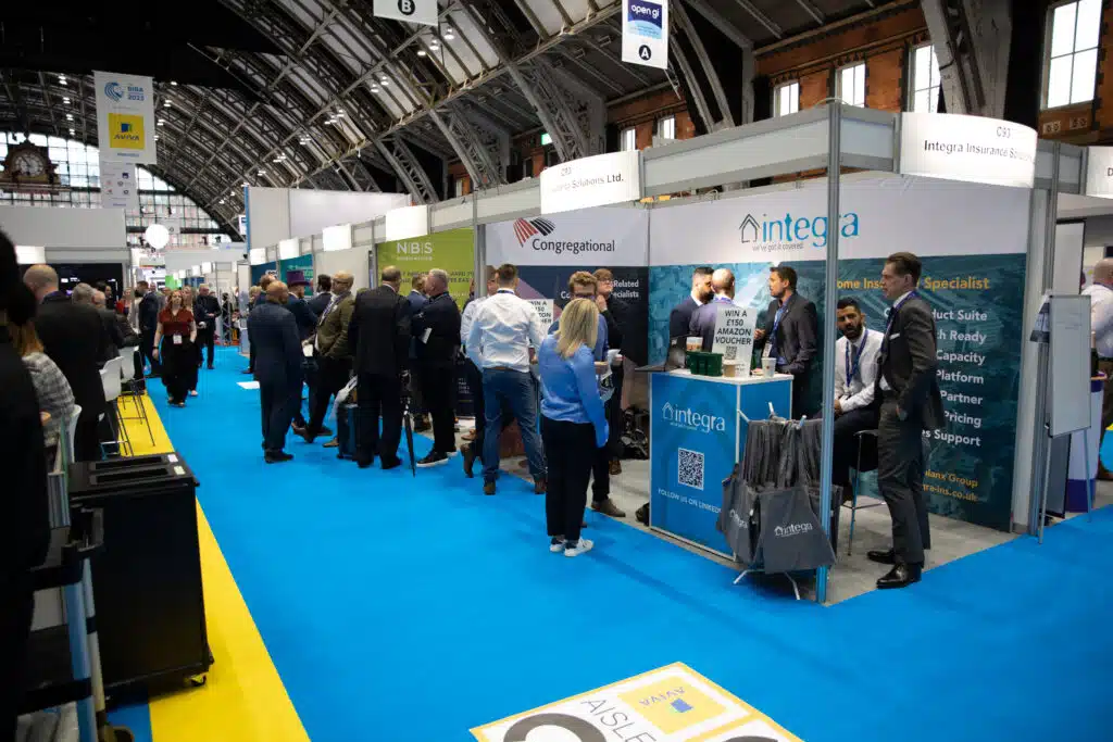 Busy aisle of exhibition stands at the BIBA conference