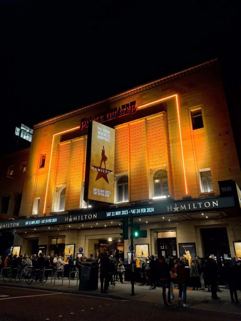 Theatre frontage with Hamilton signage lit up at night