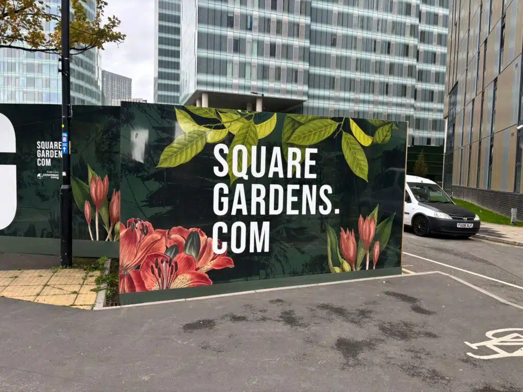 Square Gardens branded construction hoarding with floral print