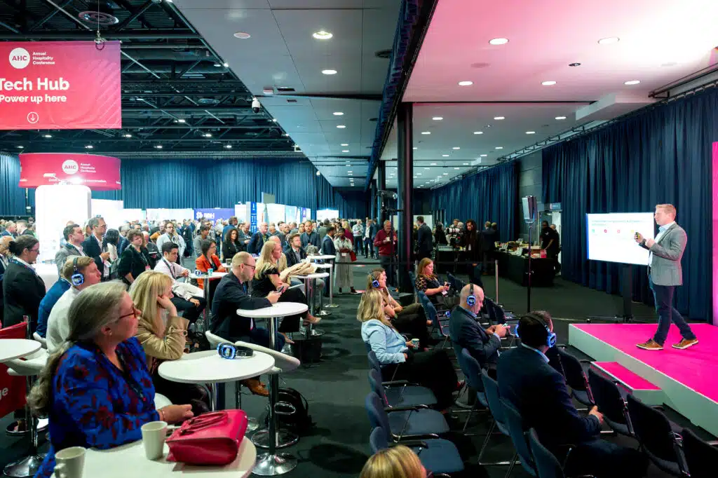 Seating area with pink branding at the Annual Hospitality Conference