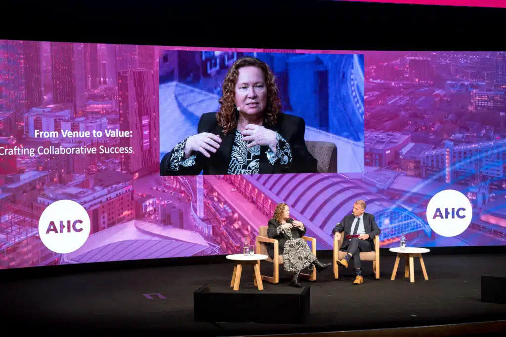 Panel on the AHC main stage with large screen graphics