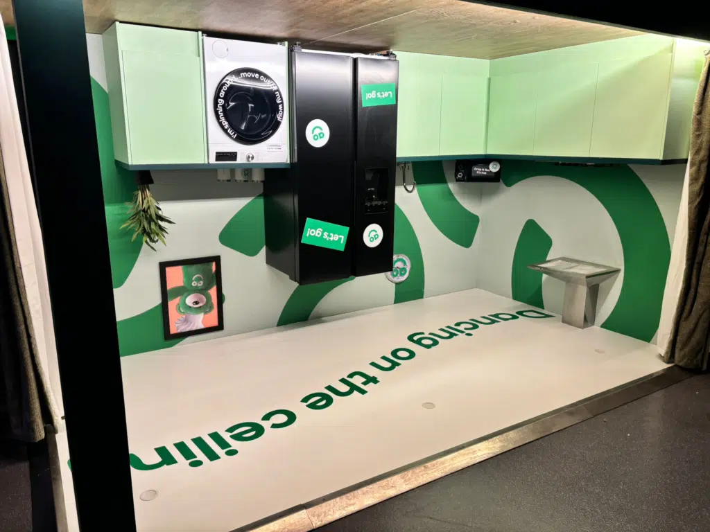 Green AO branded wall and ceiling graphics in an arena space
