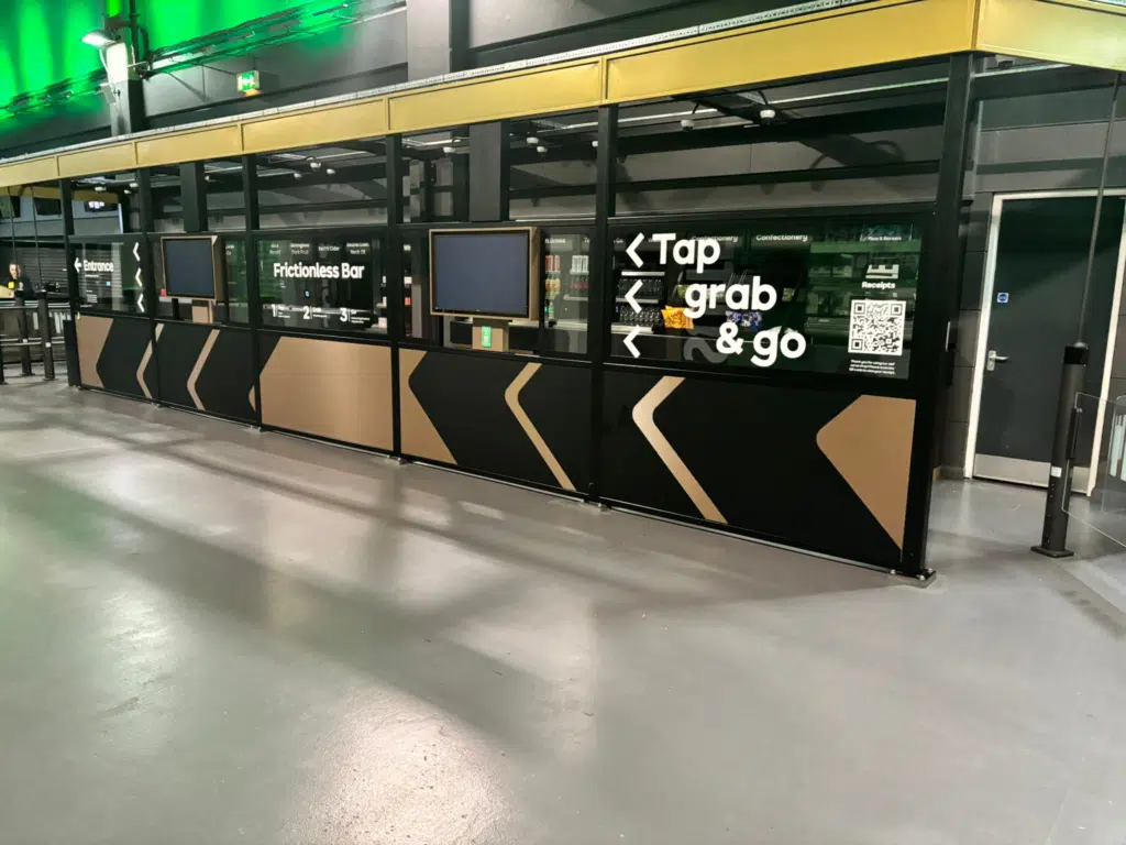 'Tap, grab and go' kiosk graphics on the AO Arena concourse
