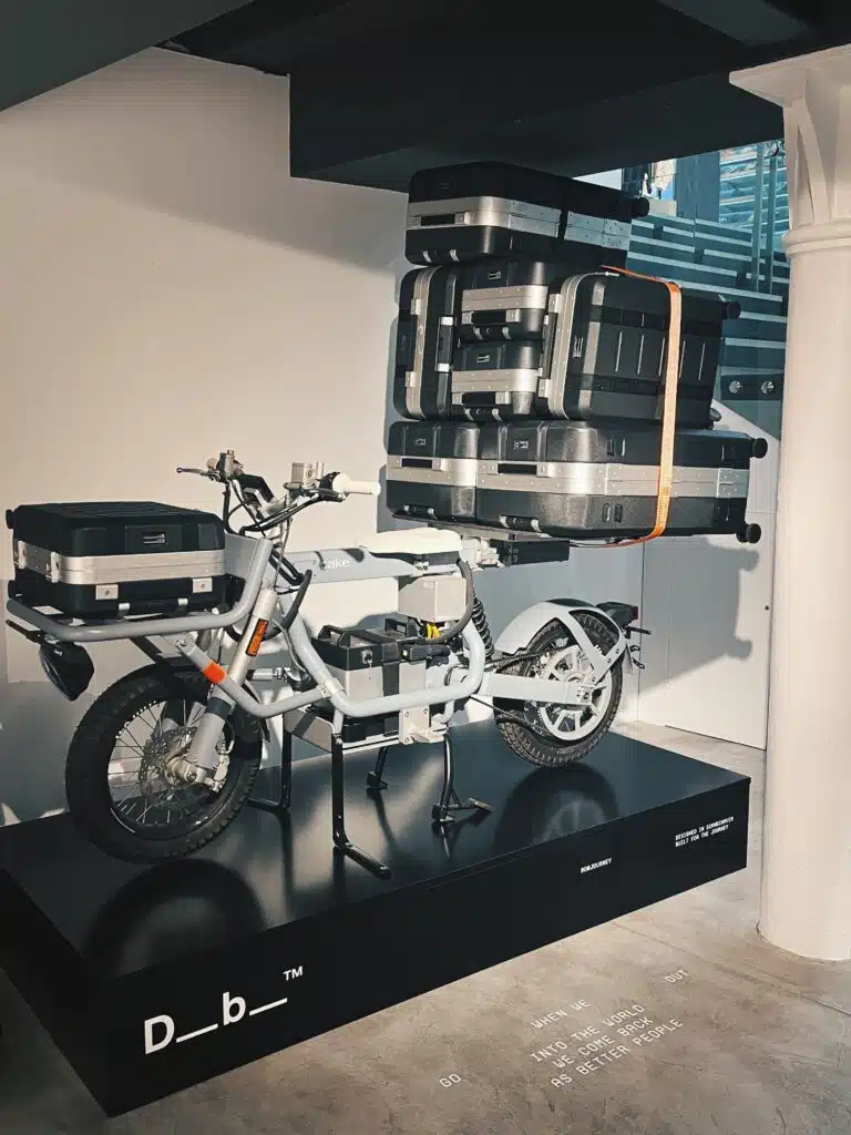 DB Luggage display with a motorbike and branded plinth at Sevenstore