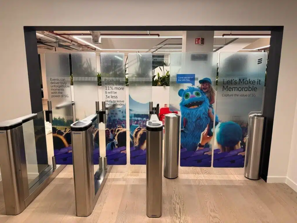 Ericsson branded glass manifestation behind office entrance gates