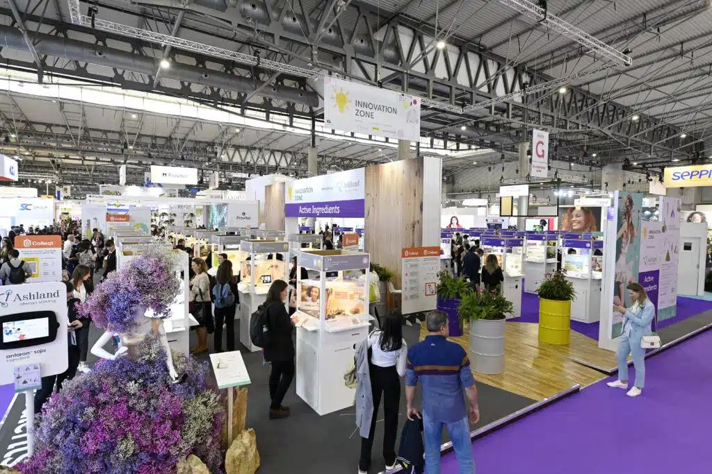 Exhibition hall at In-Cosmetics with printed stands