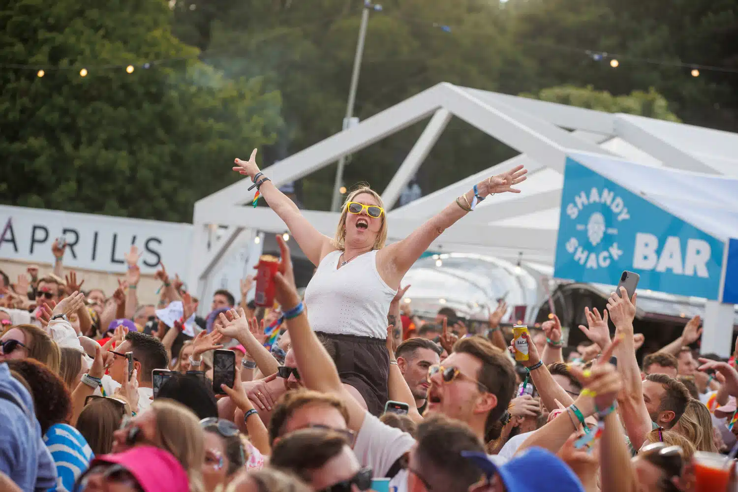 Festival crowd in front of a Co-op branded bar