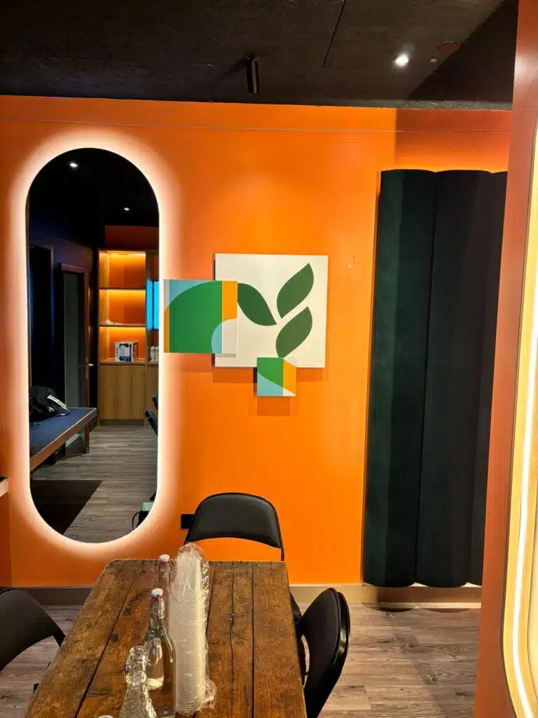 Herbalife branded lounge with orange wall graphics