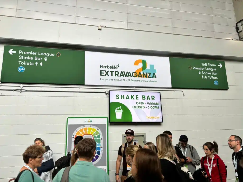 Herbalife Extravaganza wayfinding signage above a crowd
