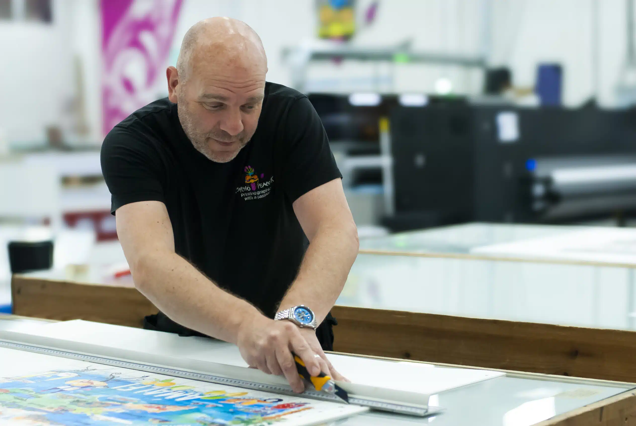 PP Graphics team member finishing a large format print