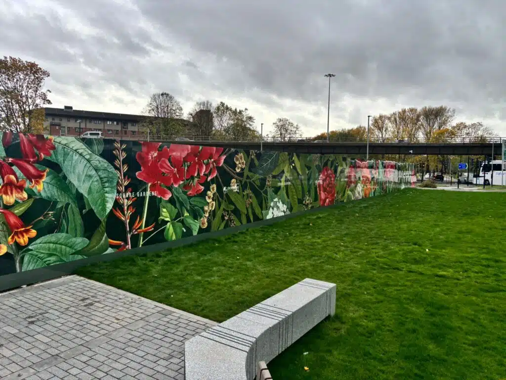 Botanical hoarding graphics around a landscaped development site
