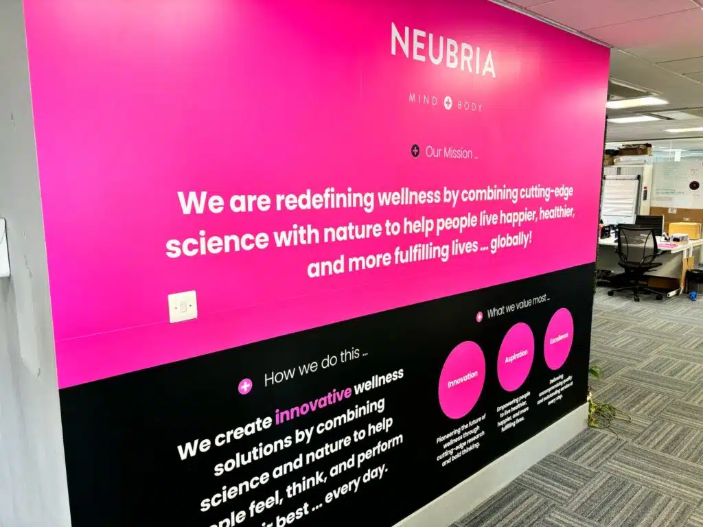 Neubria pink branded wall graphic in an office