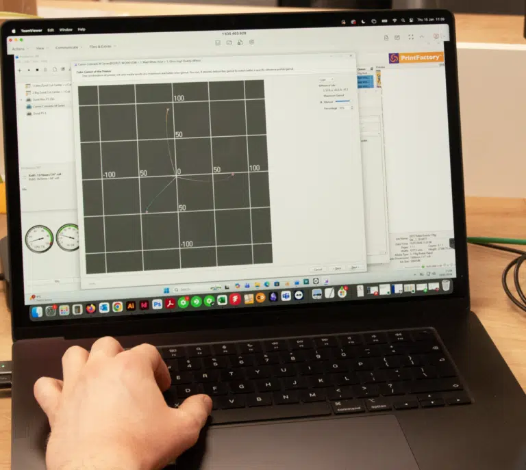 Designer setting up an artwork layout on a laptop