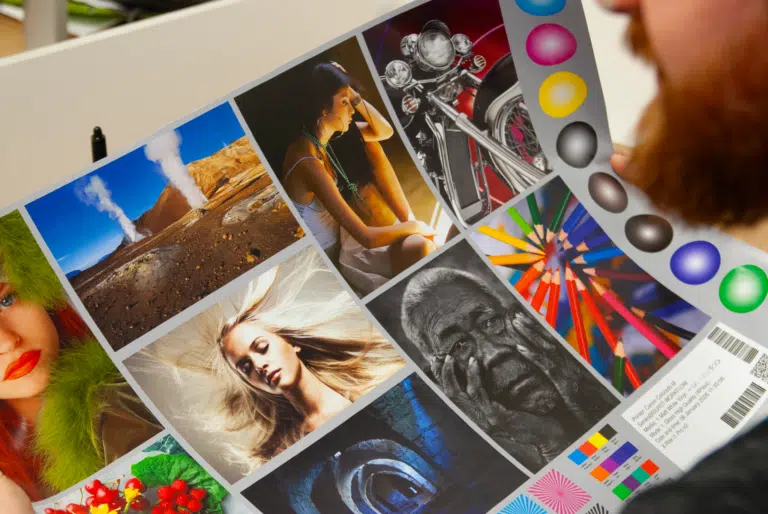 Printed colour proofs and samples laid out on a desk